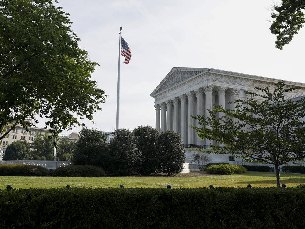 The U.S. Supreme Court building, pictured in June. Legal experts and election officials say the 14th Amendment question is likely to end up in the courts.