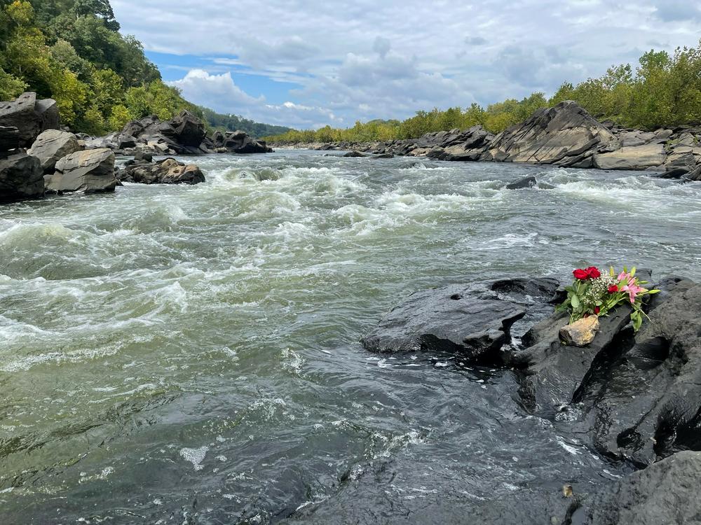 Washington-area whitewater kayakers lay flowers on the Potomac's Little Falls rapid near the rocks that entrapped visiting kayaker Ella Mills.
