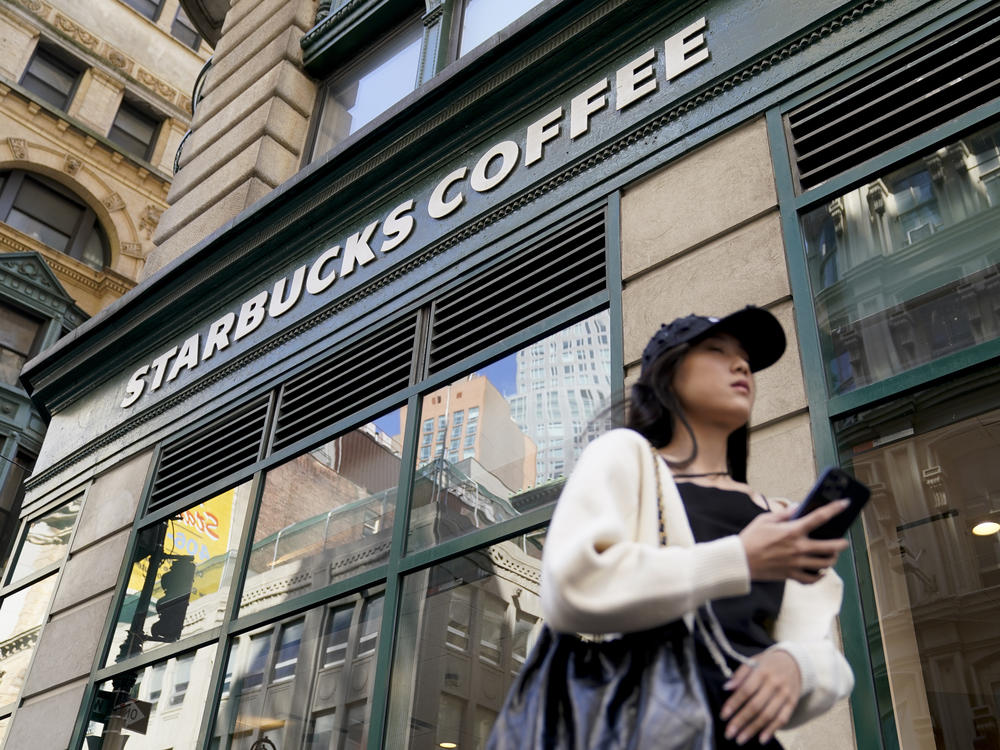 Pedestrians pass a Starbucks in the Financial District of Lower Manhattan in New York on June 13.