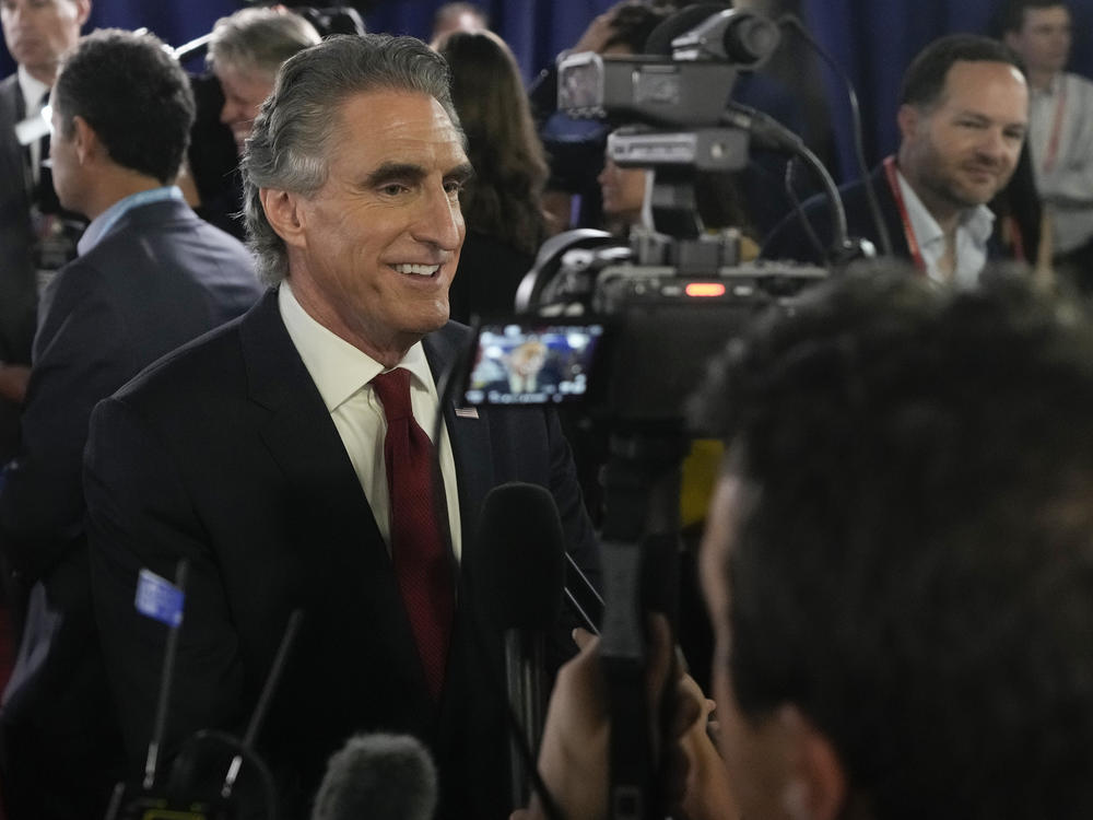 North Dakota Gov. Doug Burgum speaks to reporters in the spin room after a Republican presidential primary debate on Aug. 23.