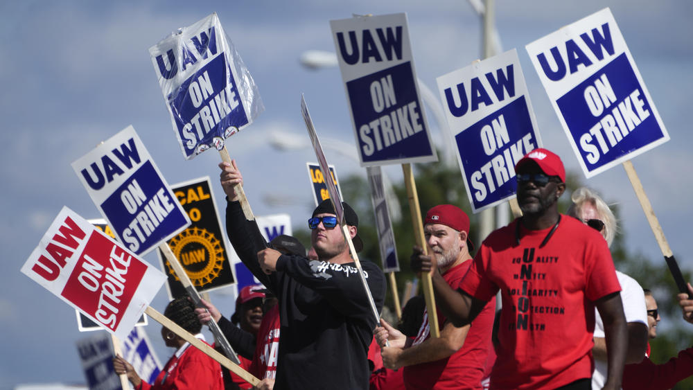 United Auto Workers members walk the picket line at the Ford Michigan Assembly Plant in Wayne, Mich., on Monday.