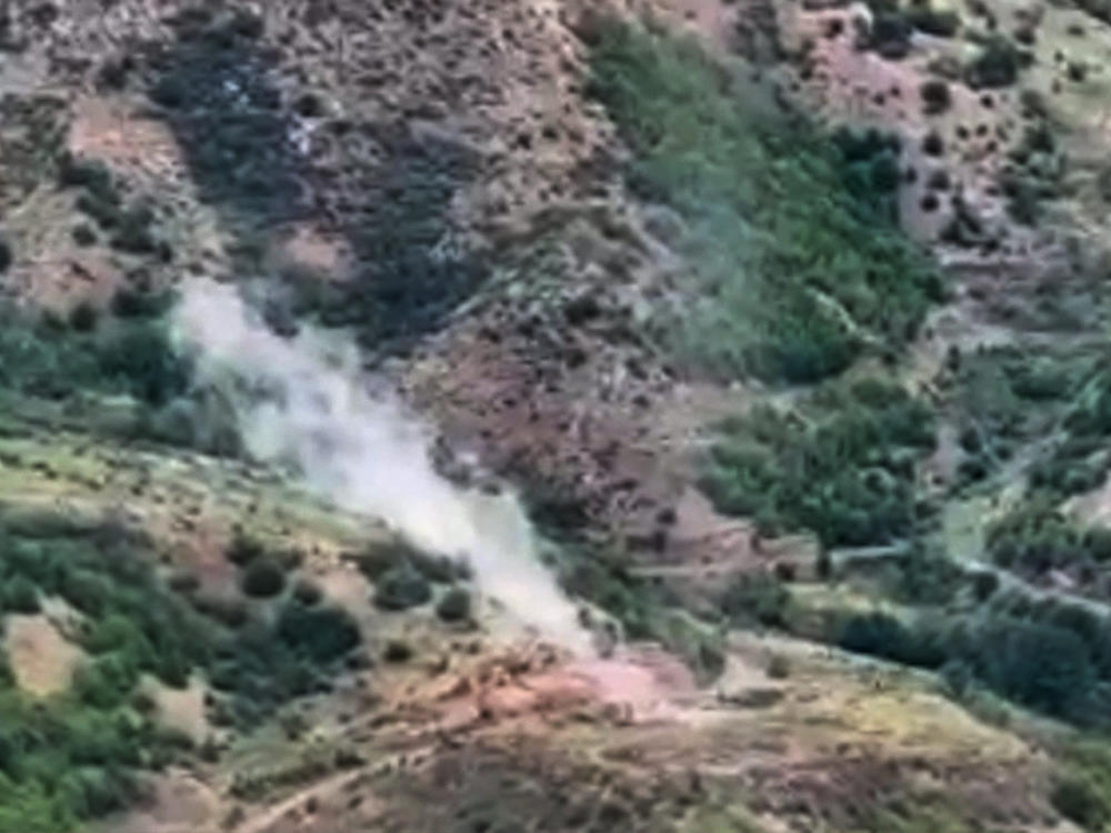In this photo taken from video released by Defense Ministry of Azerbaijan on Tuesday, Sept. 19, 2023, smoke rises over an area which Azerbaijan says hosts Armenian forces' positions in the breakaway territory of Nagorno-Karabakh in Azerbaijan.