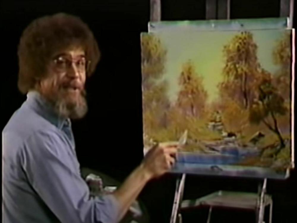 A screenshot from the premiere of <em>The Joy of Painting</em> shows the painter Bob Ross with the work, A Walk in the Woods, which is up for sale.