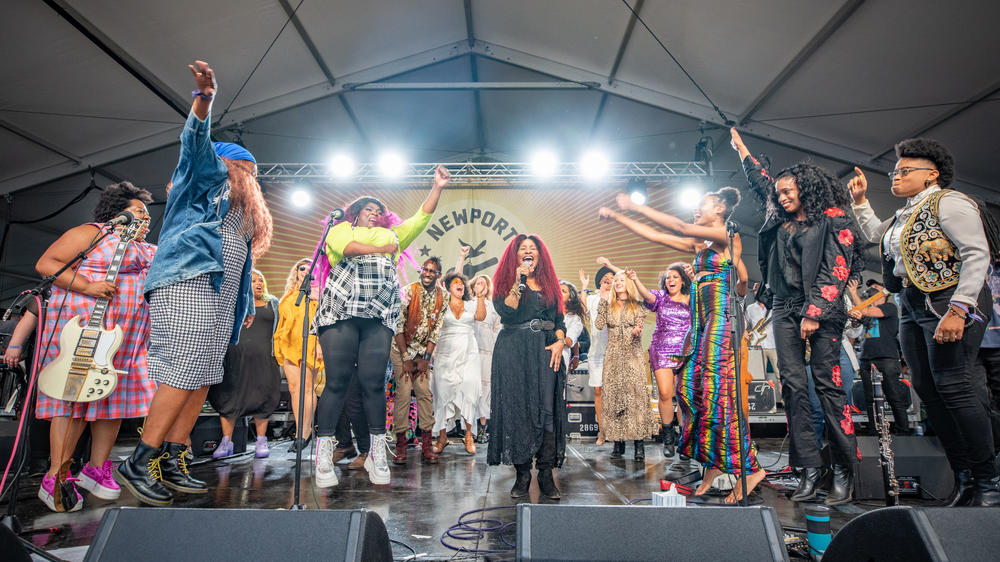 In 2021, following the release of her breakthrough album <em>Outside Child, </em>Allison Russell (seen here in rainbow jumpsuit, with her arms outstretched) organized the Newport Folk Festival's 