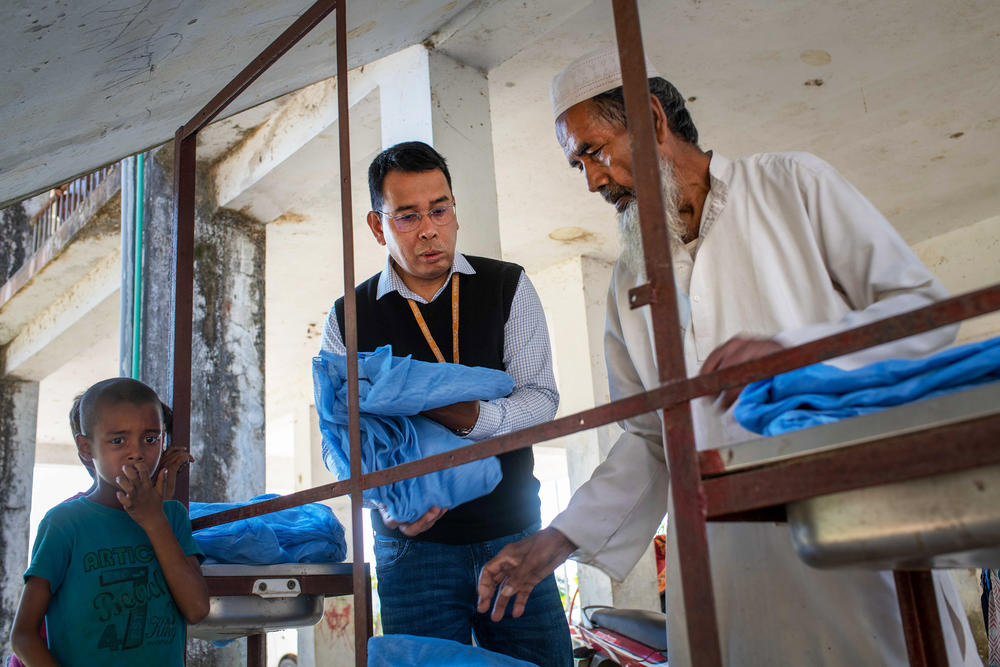 Dr. Ching Swe Phru helps disperse bed nets treated with insecticide. <strong></strong>Phru is grateful for the strides made against malaria but adds, 