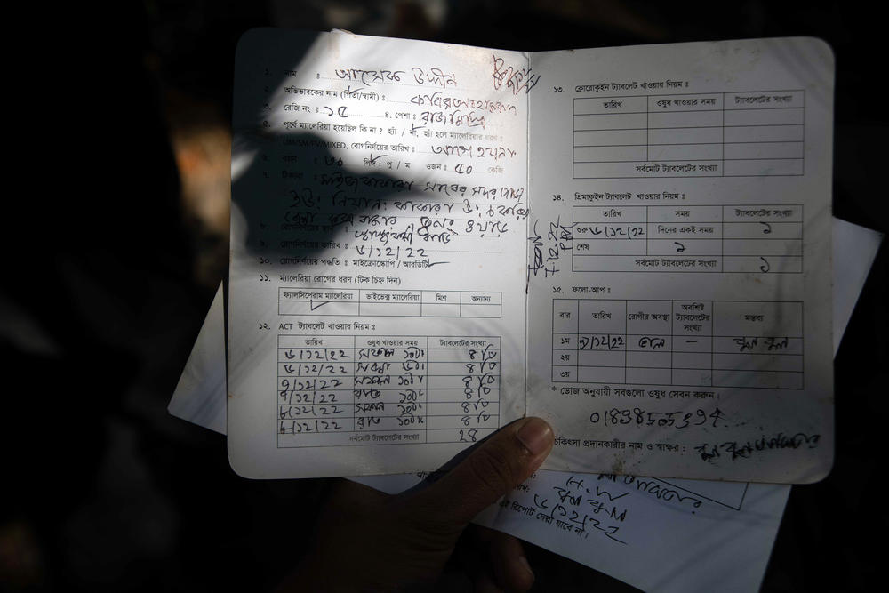 Asha Gudin, a malaria patient in Bangladesh, made a full recovery in three days, thanks to a quick diagnosis from a local health worker and an effective drug called artemisinin. Here, Gudin displays his treatment card.