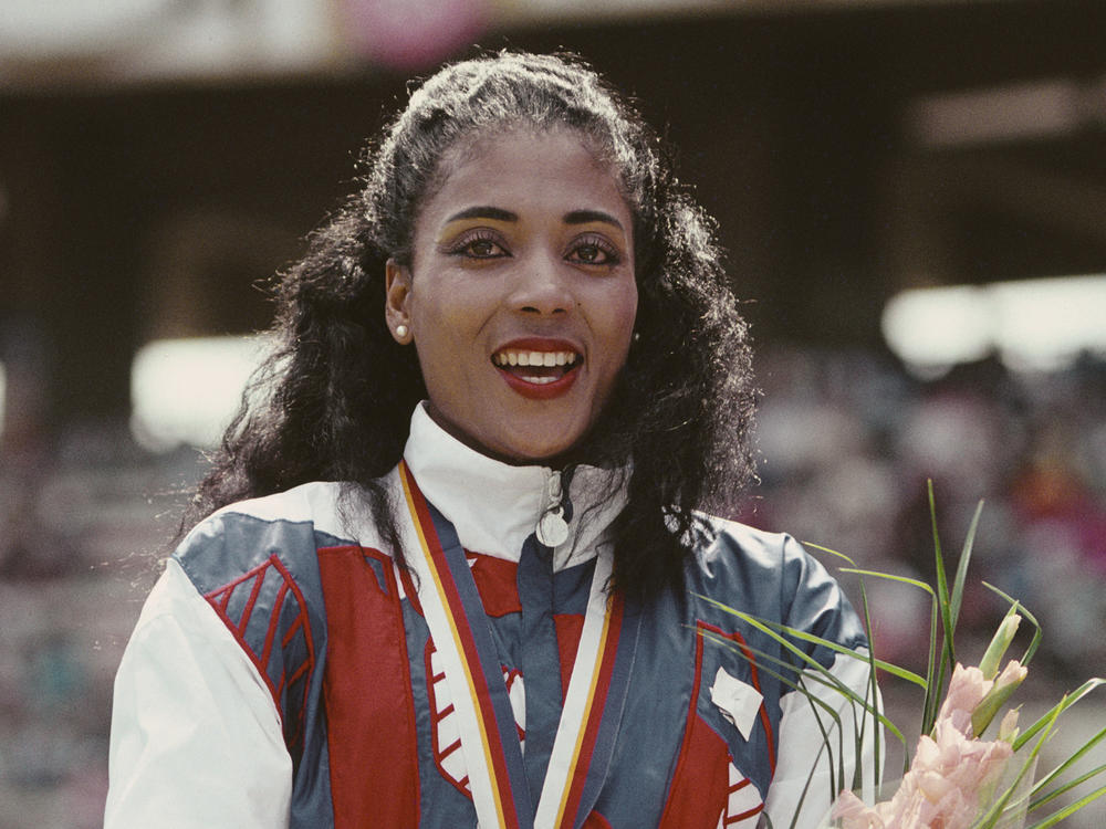 Florence Griffith-Joyner celebrates with her gold medal after winning the Women's 100 meters final event during the 1988 Summer Olympic Games in Seoul, South Korea.