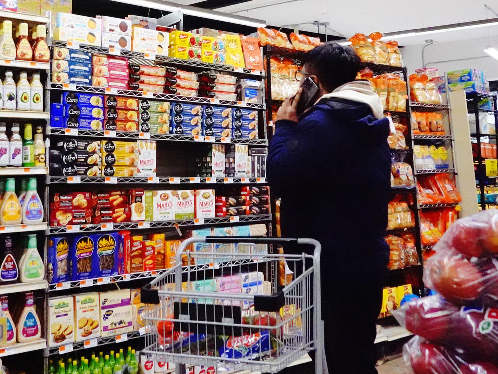 People shop at the Ideal Fresh Market in Brooklyn in New York City on Jan. 12, 2023. Inflation has eased substantially this year but still remains above the Fed's target.