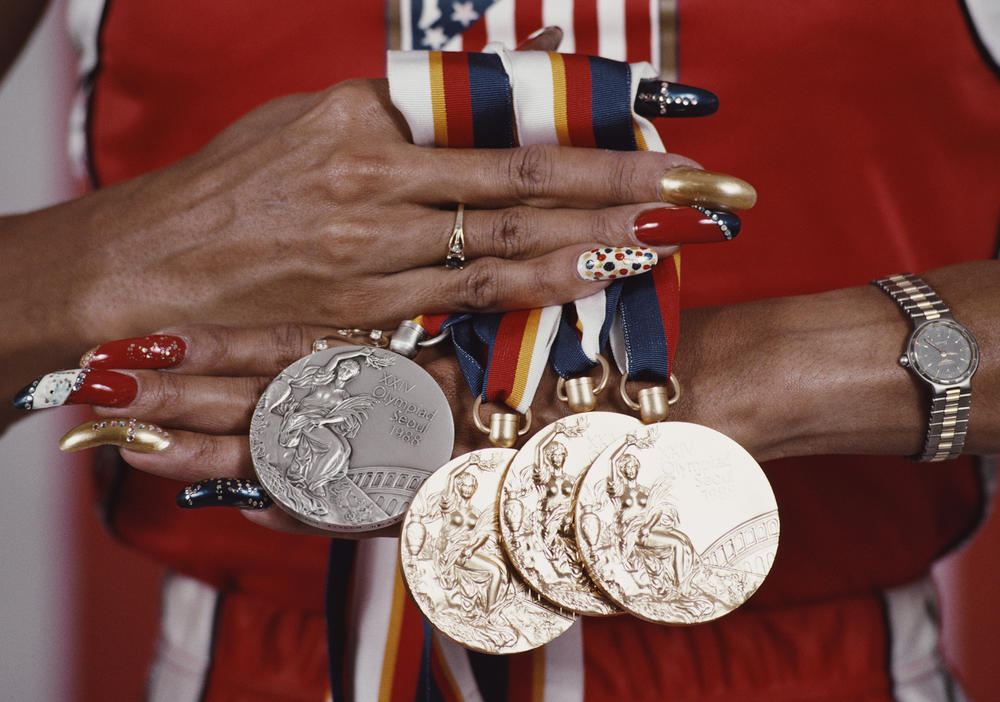 Griffith Joyner displays her medals from the 1988 Summer Olympic Games. She won gold in the Women's 100, 200 and 4x100 meters relay and silver for the 4x400 meters.