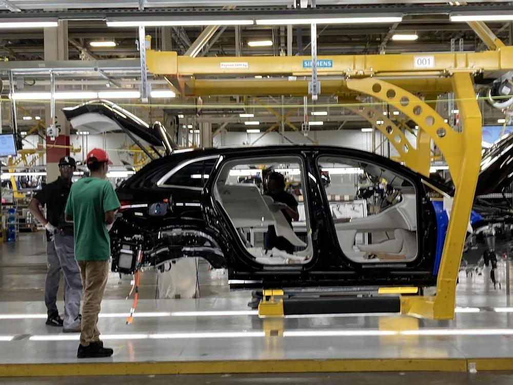 Autoworkers at Mercedes plant in Vance, Ala., assemble an all-electric SUV.
