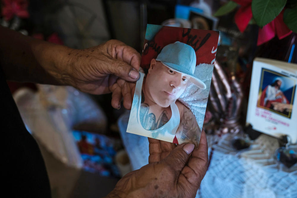 Margarita Ramirez holds a photo of her son, Jeffrey Ramirez. It took over a year for Jeffrey to see a specialist after he first asked for medical attention.