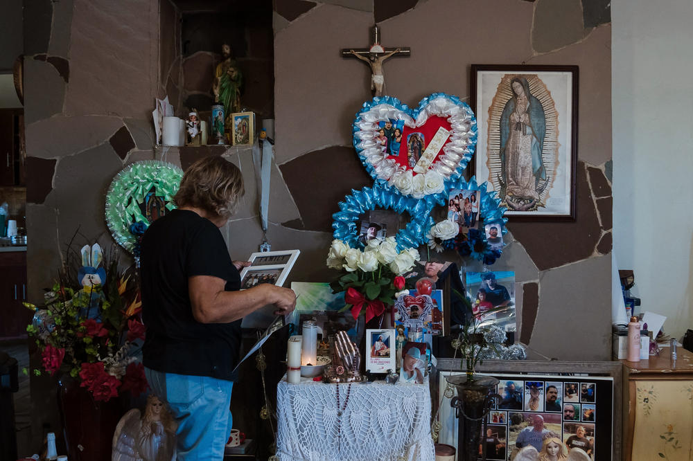 Margarita Ramirez stands in front of an altar for Jeffrey at her home.