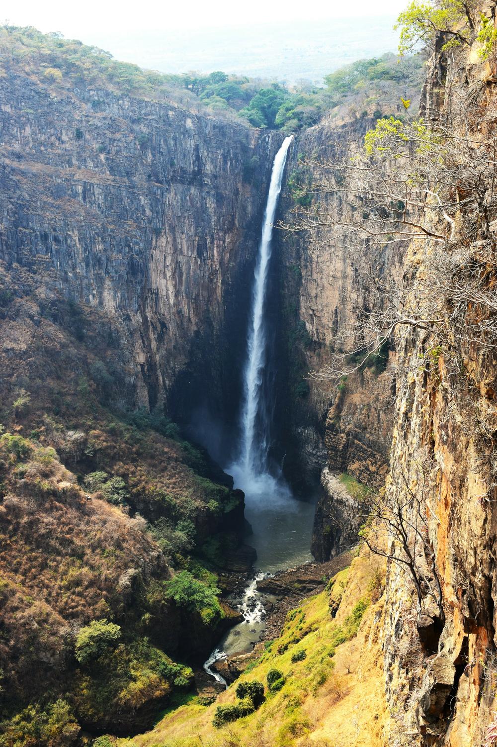 The Kalambo Falls on the Kalambo River is a 772-foot single-drop waterfall on the border of Zambia and Rukwa Region, Tanzania, near the location of the dig.