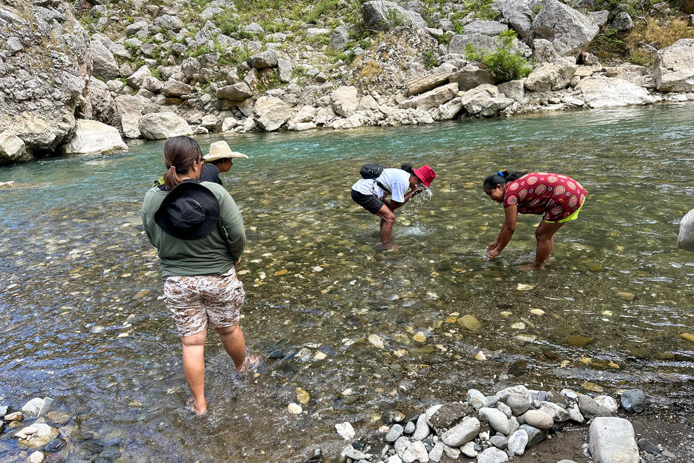 Maria Clara Dullas (far right) and other community leaders of the Indigenous Dumagat community wash their faces in the Agos River. Their people, mostly farmers, have lived off the river for generations.