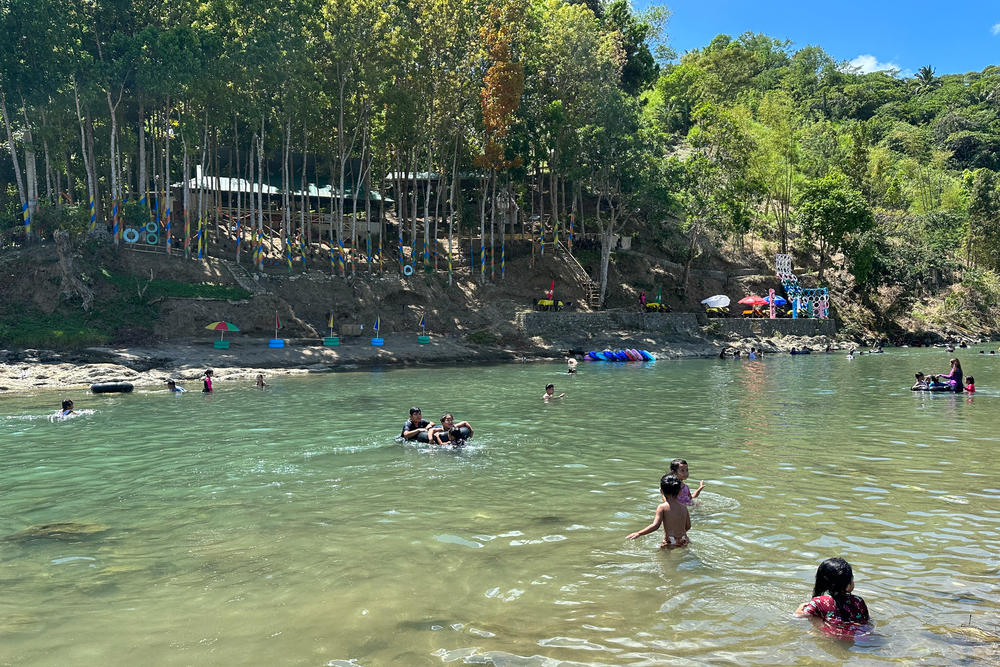 Children play in the Agos River in the tourist village of Daraitan in the Philippines' Rizal province. In late April, temperatures are high and the humidity is stifling — driving tourists and residents alike into the river's cool, running waters.