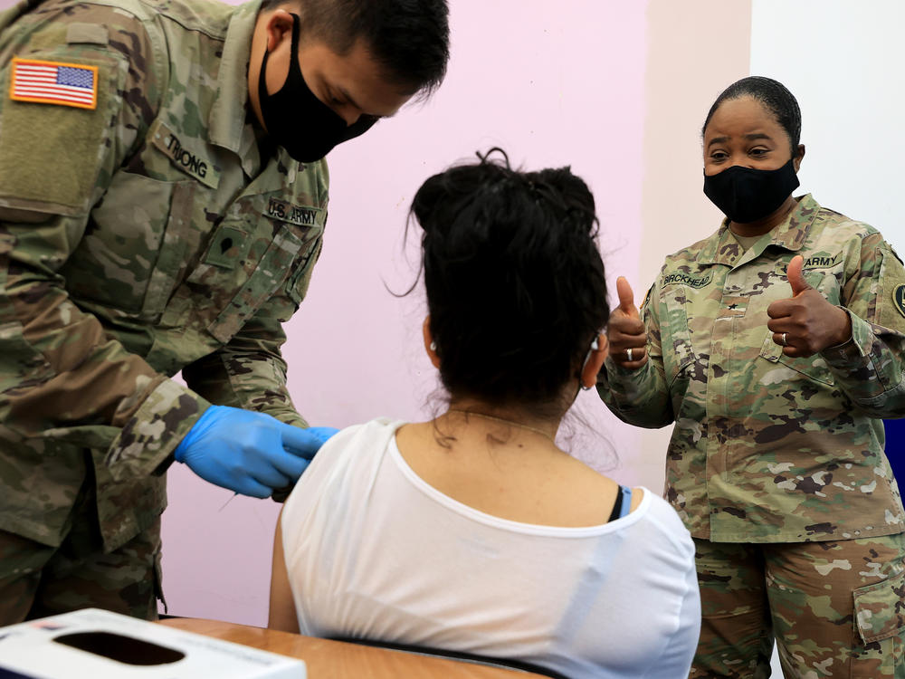 Maryland National Guard Maj. Gen. Janeen Birckhead visits with a woman as she receives her Moderna coronavirus vaccine in Wheaton, Md., in 2021.