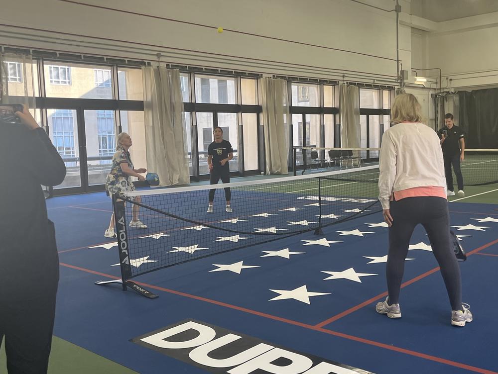 Senator Kirstin Gillibrand, D-N.Y., (on left) faces off against Sen. Cynthia Lummis, R-Wy., (on right) with members of the D.C. professional pickleball team at an event with the Senate pickleball caucus.