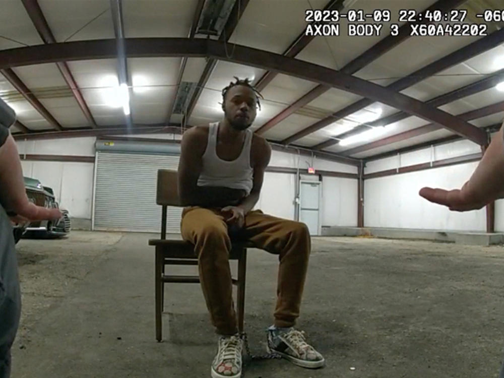 In this image from Baton Rouge Police Department body camera video, officers interact with Jeremy Lee inside a warehouse in Baton Rouge on Jan. 9, 2023. Lee sued the department in August 2023 alleging officers abused him in the police warehouse nicknamed the 