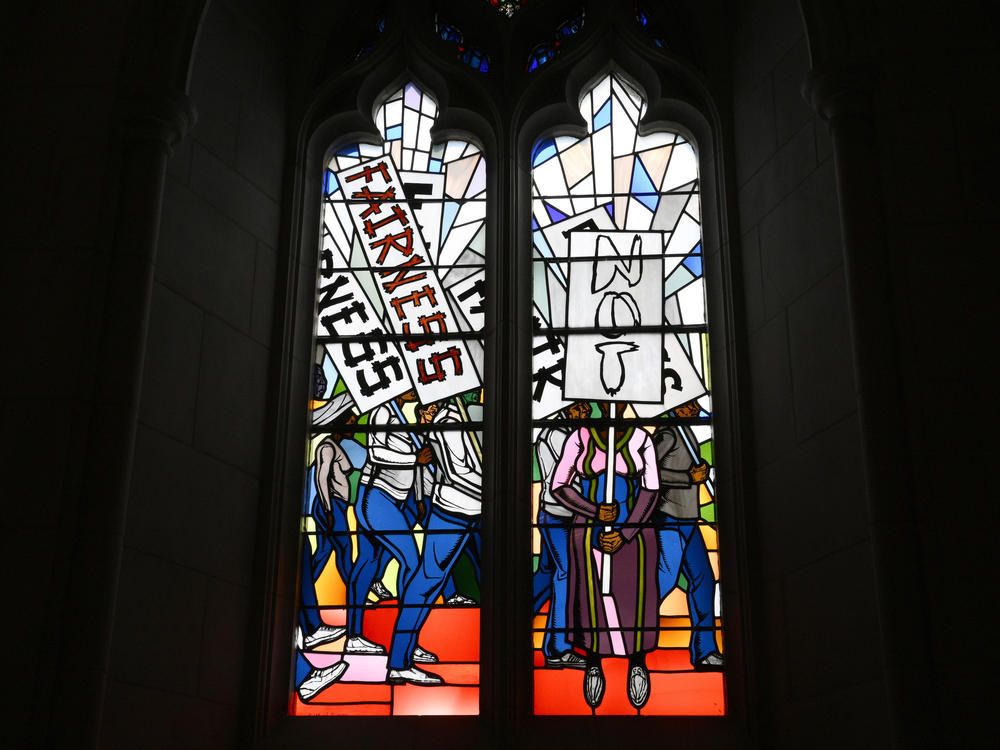 Light shines through new stained-glass windows with a theme of racial justice during an unveiling and dedication ceremony at the Washington National Cathedral for the windows on Saturday, Sept. 23 in Washington.