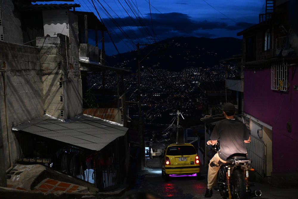 People on a hillside neighborhood Saturday evening.