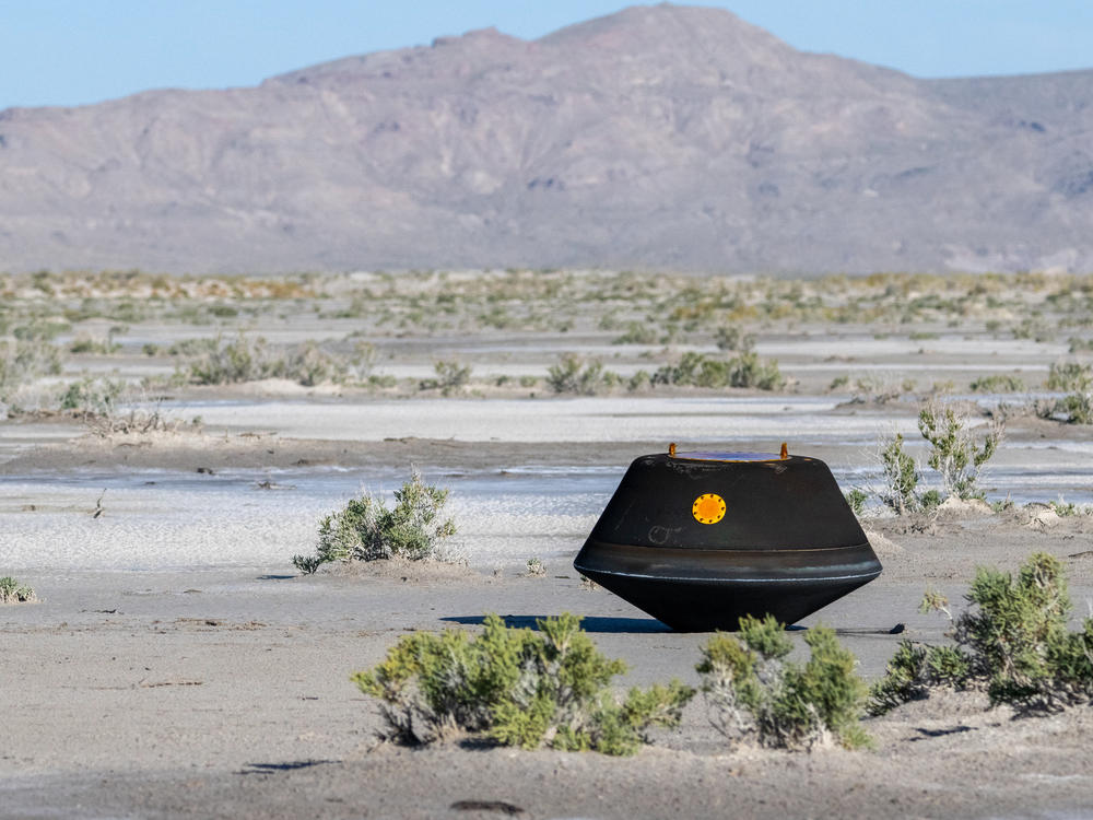 The sample return capsule from NASA's OSIRIS-REx mission is seen shortly after touching down in the desert at the Department of Defense's Utah Test and Training Range.