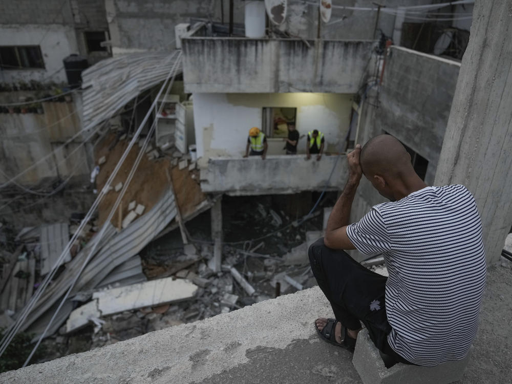 Palestinians inspect a damaged building following an Israeli army raid in Nour Shams refugee camp in the northern West Bank, Sunday, Sept. 24, 2023. Palestinians said at least two people were killed in the raid, which the army said was carried out to destroy a militant command center and bomb-storage facility in the building.