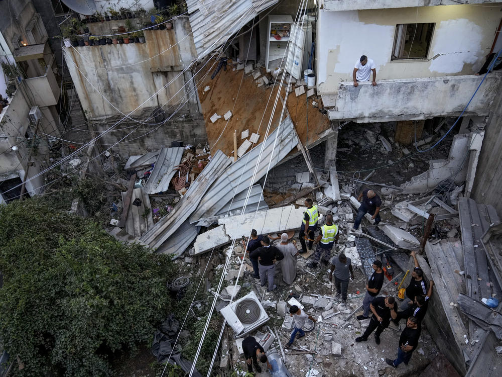 Palestinians inspect a damaged building following an Israeli army raid in Nour Shams refugee camp in the northern West Bank, Sunday, Sept. 24, 2023. Palestinians said at least two people were killed in the raid, which the army said was carried out to destroy a militant command center and bomb-storage facility in the building.