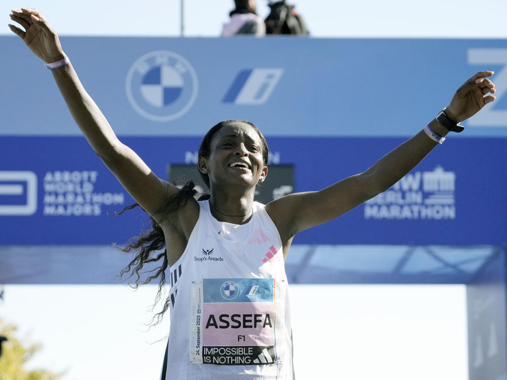 Ethiopia's Tigist Assefa celebrates as she crosses the finish line to win the women's division of the Berlin Marathon in world record time in Berlin, Germany, Sunday, Sept. 24, 2023.
