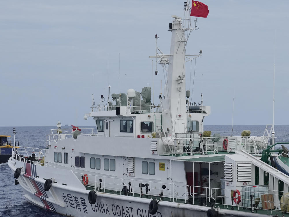 FILE - A Chinese coast guard ship blocks the way of a Philippine supply boat as it heads towards Second Thomas Shoal, locally known as Ayungin Shoal, at the disputed South China Sea on Aug. 22, 2023.
