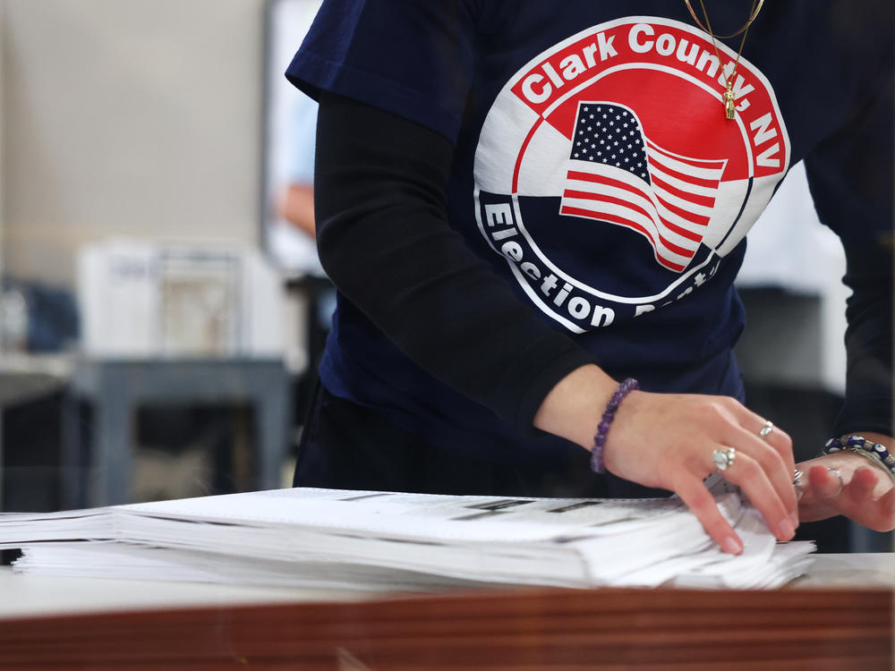 A Clark County Election Department worker sorts ballots on Nov. 9, 2022, in North Las Vegas, Nev. Nearly 60% of the state's county voting officials are new since 2020, according to a new report.
