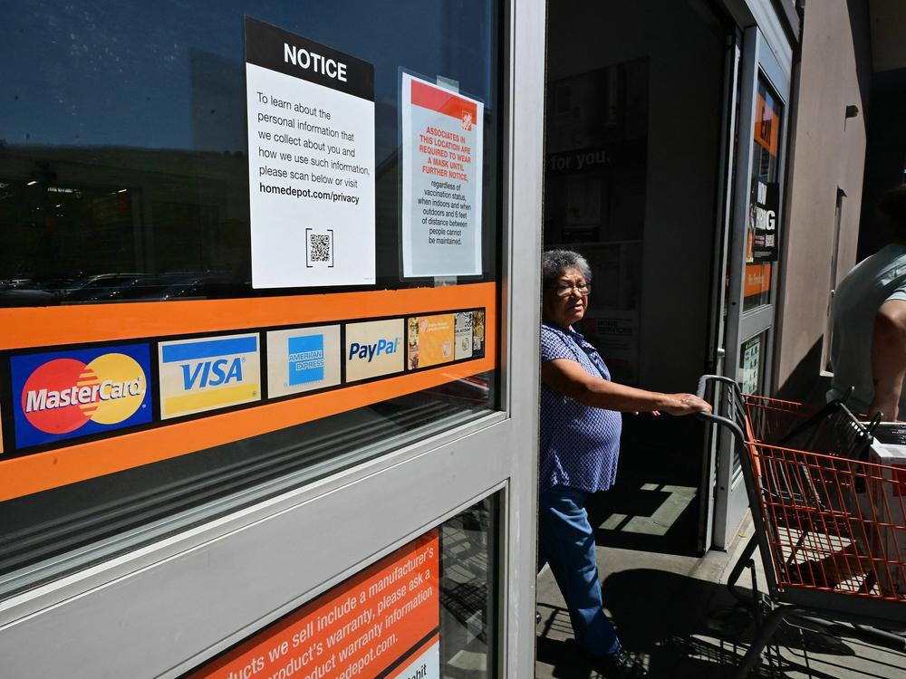 A display of credit cards accepted for use is seen on a door as a shopper steps out of a store in Monterey Park, Calif., on Sept. 12, 2023.