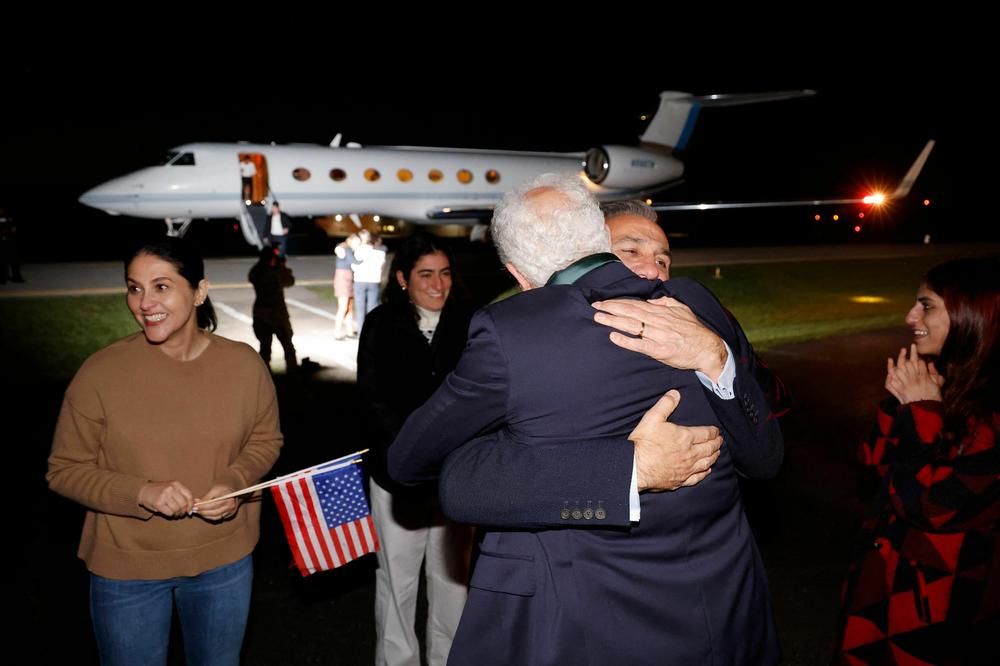 Freed U.S. national Emad Shargi greets a family member after he and four others, who were released in a prisoner swap deal between U.S. and Iran, disembark from an airplane at Davison Army Airfield at Fort Belvoir, Virginia, on September 19.