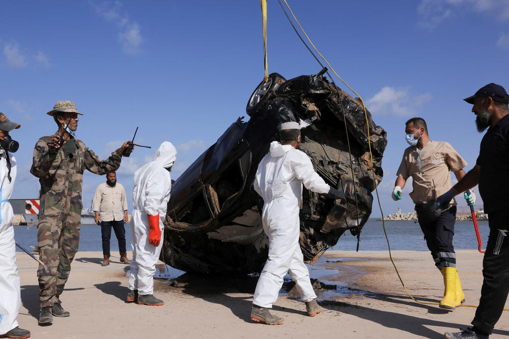 Field Medicine and Support Center workers handle a vehicle recovered from the sea after it was swept away during floods in Derna, Sept. 20.
