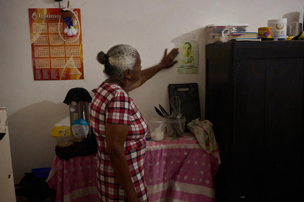 David's mother looks at a picture of a young girl — a granddaughter who used to live with them. 