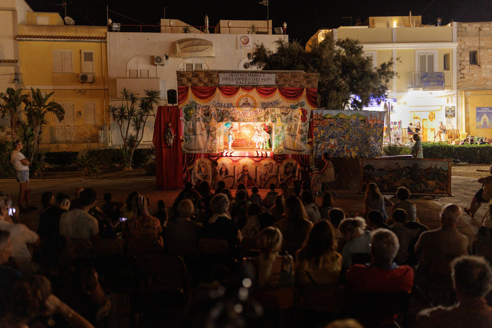 A crowd watches Sferlazzo's puppet show.
