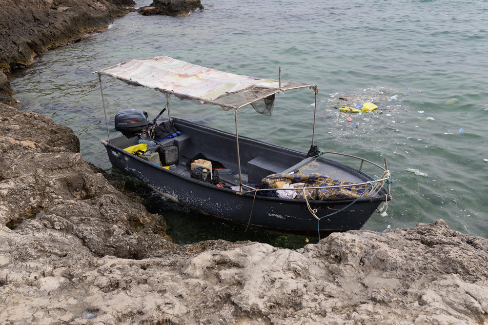 A wooden boat used by migrants to arrive at Lampedusa is seen near the beach of Guitgia, Lampedusa, Sept. 20.