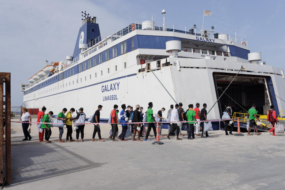 Migrants in Lampedusa's Porto Vecchio wait to be transferred to Porto Empedocle, Sept. 21.