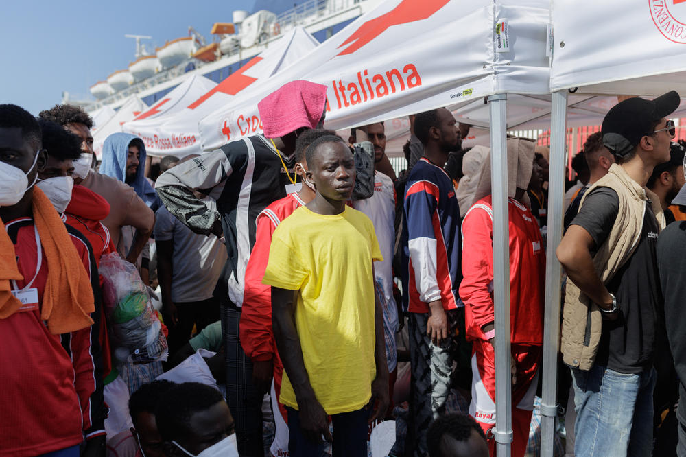 Migrants wait at Lampedusa's Porto Vecchio to be transferred by ferry to Porto Empedocle, Sept. 22.
