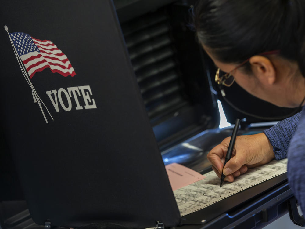 A woman marks her ballot at a polling center in Albuquerque, N.M., on Nov. 8, 2022. Republicans in the state are challenging the congressional map that was used for that election.