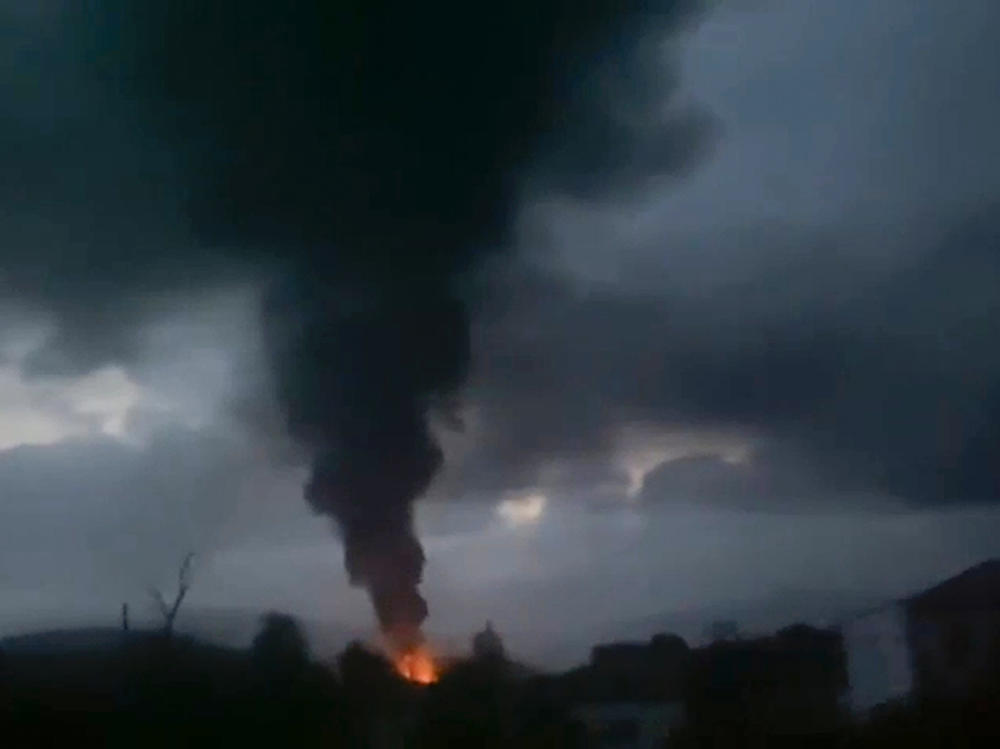 This grab taken from video distributed by Siranush Sargsyan's Twitter account on Monday, Sept. 25, 2023, shows smoke rising after a fuel depot explosion near Stepanakert, Nagorno-Karabakh.