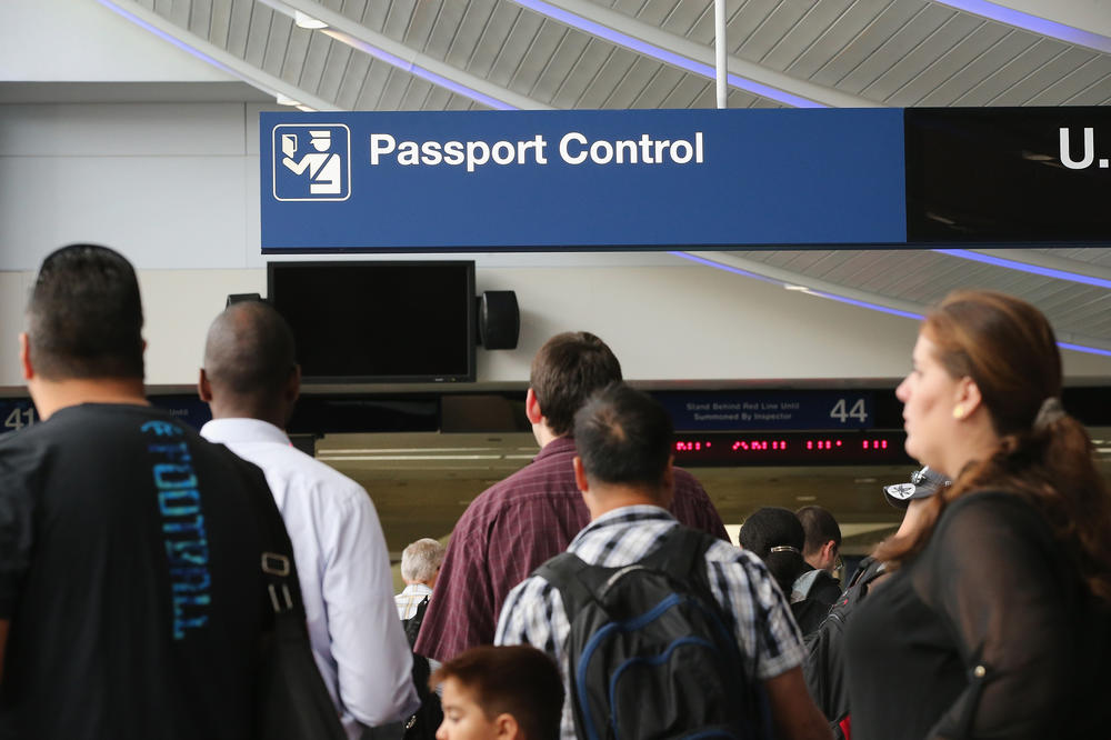 International travelers wait to have their passports checked at O'Hare International Airport in Chicago, 2014. The new agreement to allow visa-free U.S. entry to Israeli tourists and businesspeople requires Israel to end bans and restrictions on Palestinian Americans and other Arab Americans traveling to Israel.