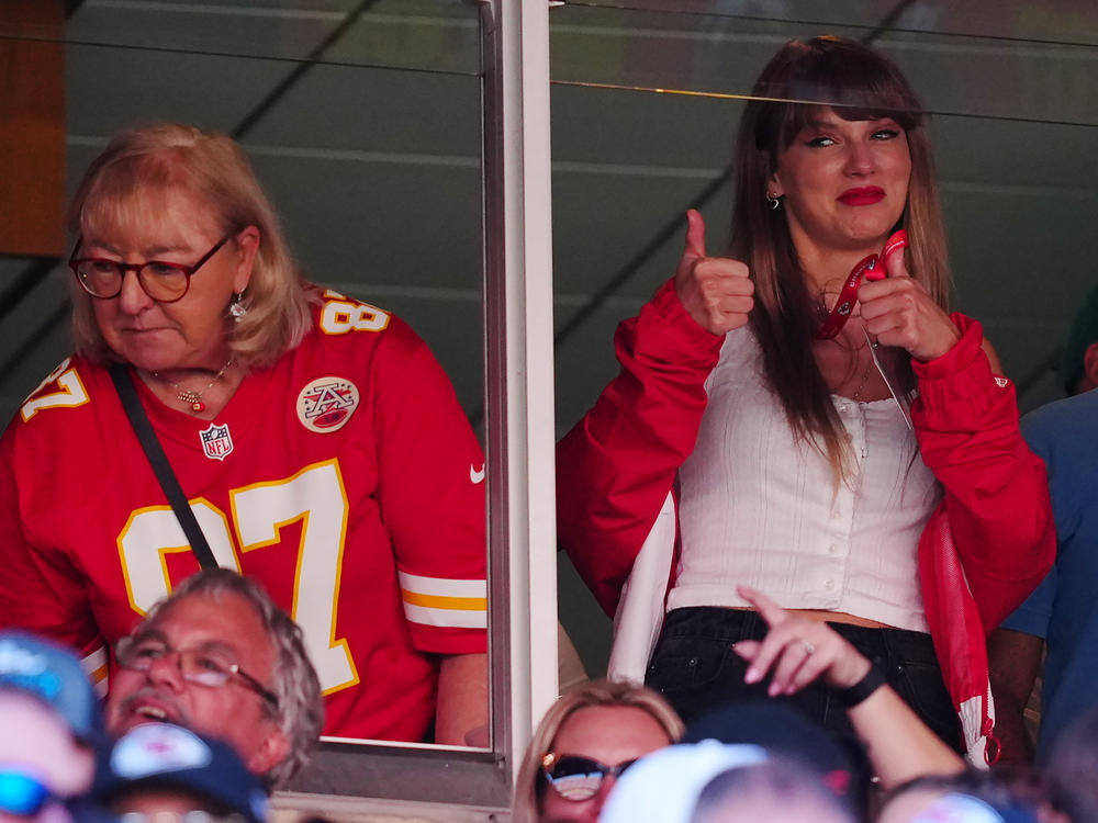 Donna Kelce, wearing her son Travis' No. 87 jersey, and Taylor Swift are seen during the Kansas City Chiefs' game with the Chicago Bears in Kansas City, Missouri. Sales of Kelce's jersey soared after Swift appeared at the game.