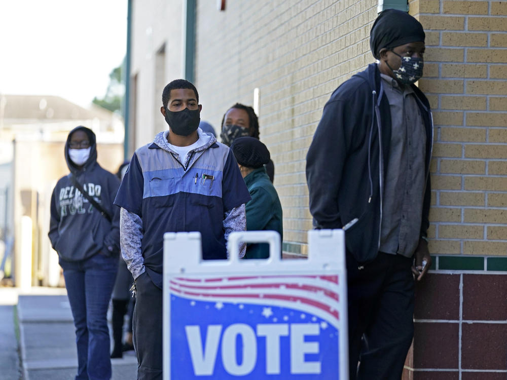 People line up to vote at the Dr. Martin Luther King Jr. Charter Elementary School in New Orleans in 2020.