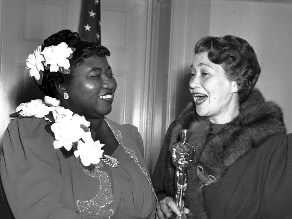 Actress Hattie McDaniel, left, appears with actress Fay Bainter, right, the night McDaniel won best supporting actress for her role in the 1939 film <em>Gone With the Wind</em> in Los Angeles on Feb. 29, 1940. The Academy of Motion Pictures Arts and Sciences has created a replacement of McDaniel's Academy Award plaque that it is gifting to Howard University.