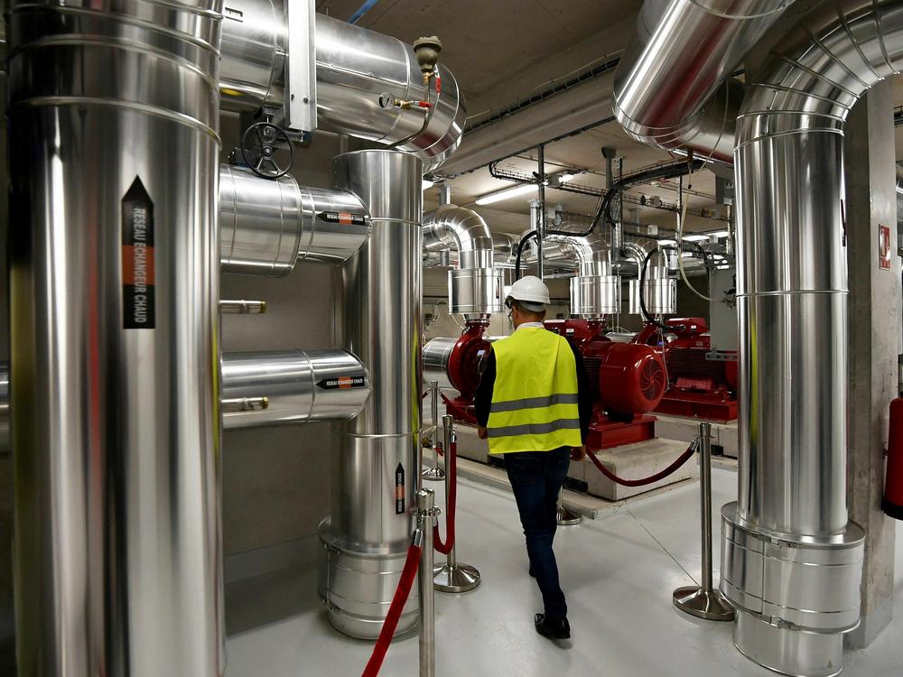 A man walks at the Thassalia marine geothermal plant. A New England energy utility is building a networked geothermal system to heat and cool 37 buildings.