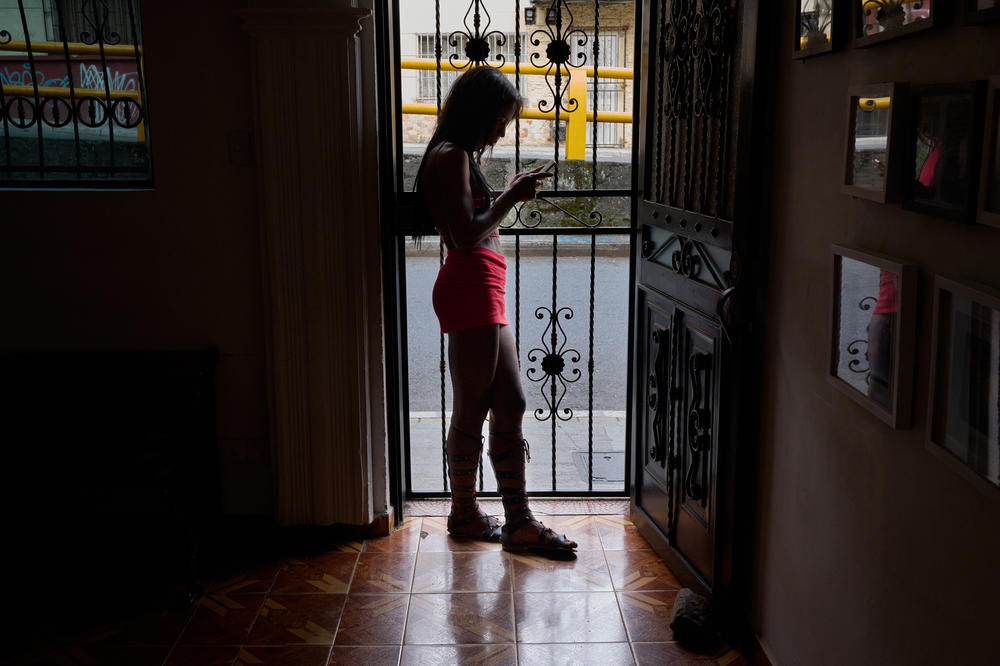 A person stands at the entrance of Caribe Casa Afirmativas, while not a shelter, is the only organization in Medellín focused on the LGBTQ community, with a hyper focus on supporting the Venezuelan population.
