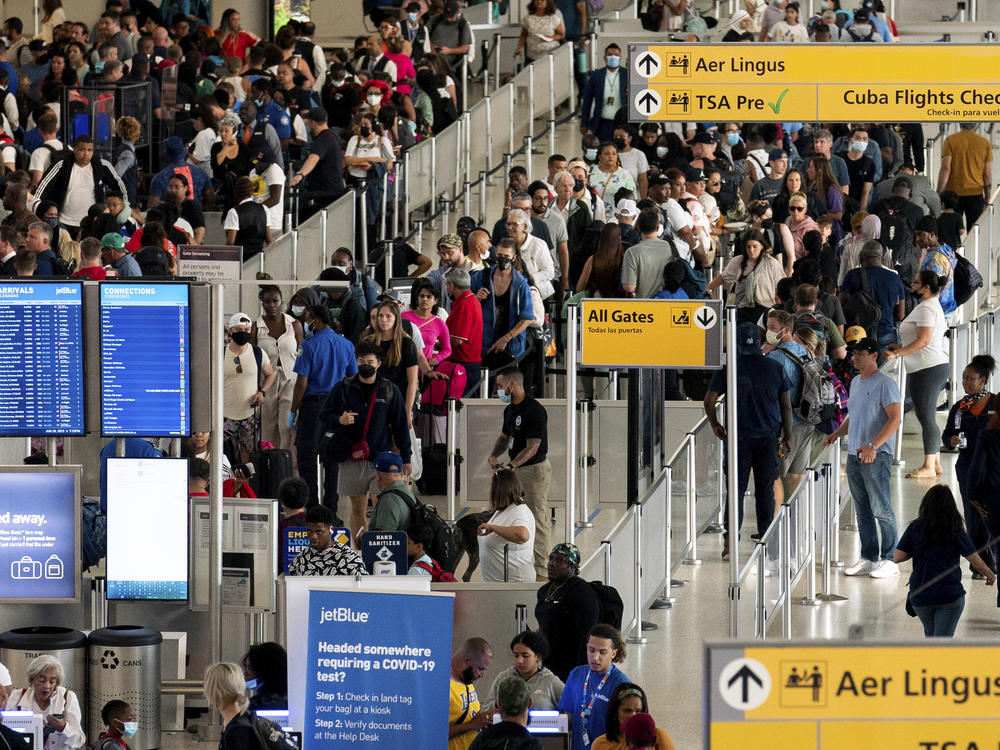 In this file photo, people wait in a TSA line at the John F. Kennedy International Airport on June 28, 2022, in New York. Both TSA and air traffic controllers as part of the Federal Aviation Administration would be considered 