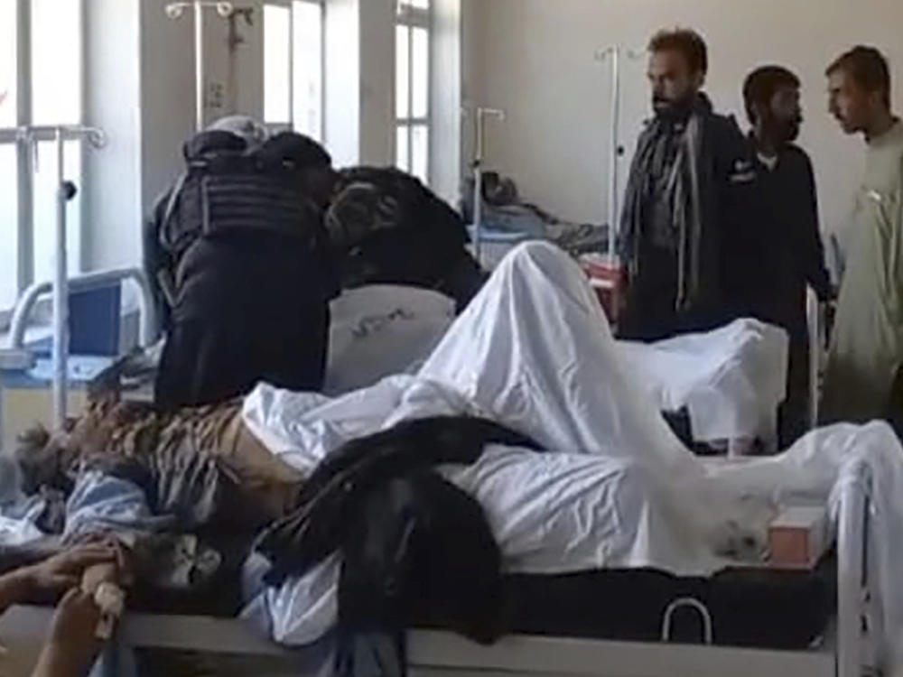 In this photo provided by the District Police Office, injured victims of bomb explosion are treated at a hospital, in Mastung near Quetta, Pakistan