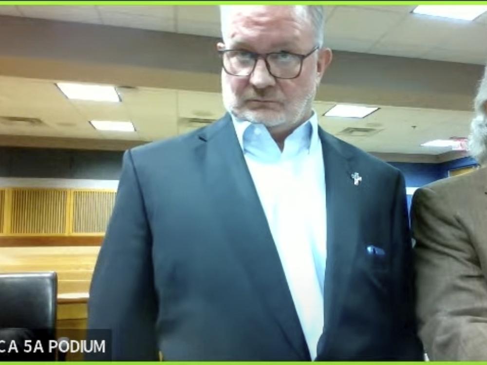 In this image made from video from Judge Scott McAfee's virtual Zoom hearing, Scott Graham Hall, left, stands with his attorney Jeff Weiner, right, in Superior Court of Fulton County before Judge McAfee on Friday, Sept. 29, 2023, in Atlanta.