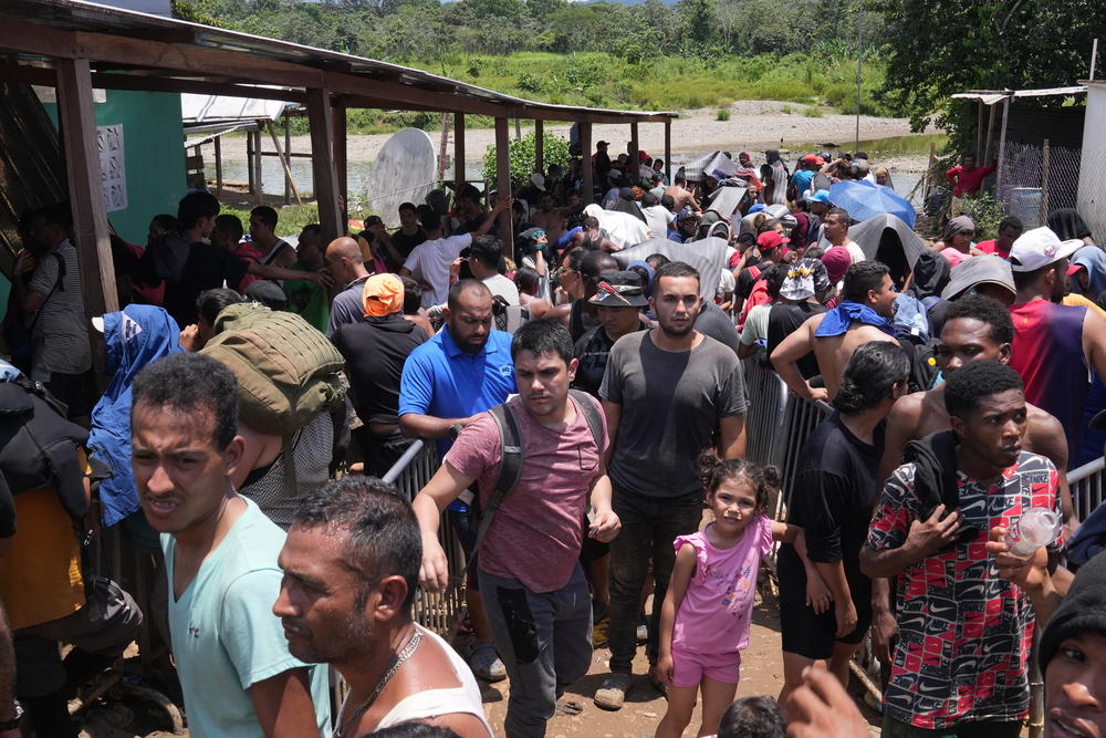 Migrants who recently crossed the Darién Gap form long lines to get transit permits from Panamanian immigration officers at the village of Bajo Chiquito, on Sept. 16.